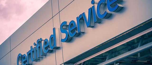 certified service sign on exterior building